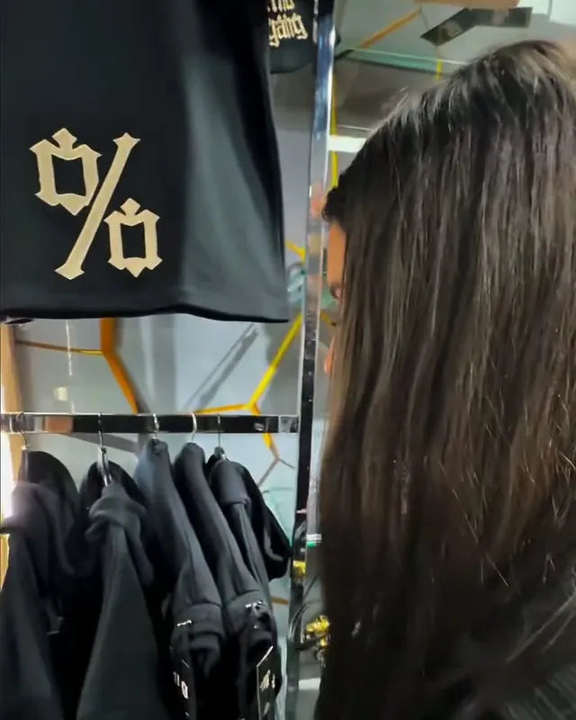 The % sweatshirt hanging in the drop store